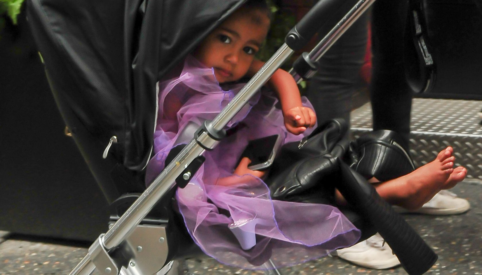 Kim Kardashian walks north west in a purple princess dress
