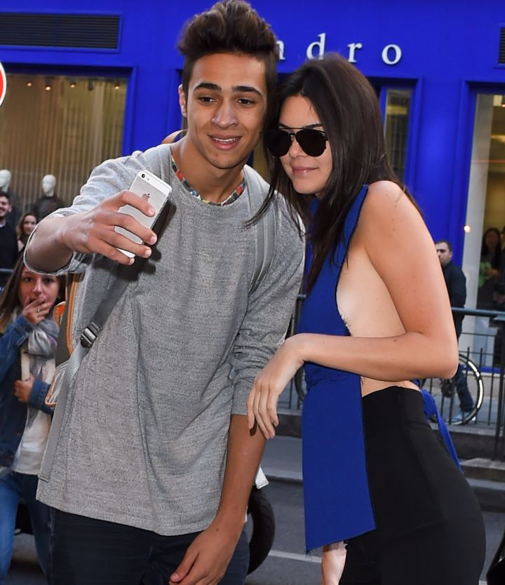 Kendall Jenner was seen posing for a selfie with a fan who tried to kiss her…Probably because she was flashing some serious side boob.