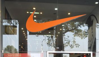 Indian men walk past Nike store in New
