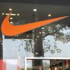 Indian men walk past Nike store in New