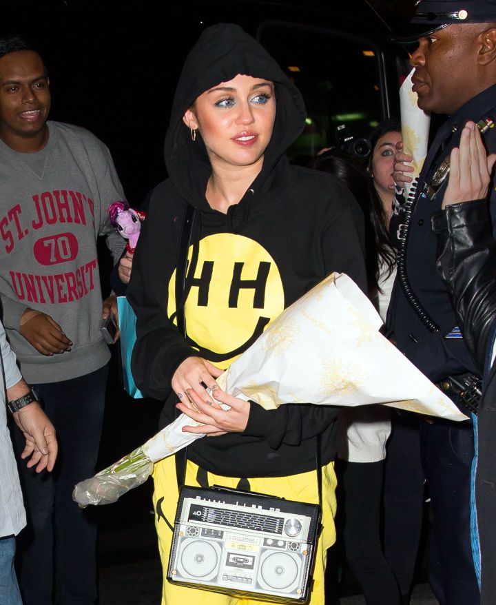 Miley Cyrus is all smiles while greeting fans at her hotel after spending 15 hours at NBC studios in NYC.