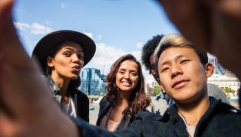 Multi cultural group of friends taking a selfie in London