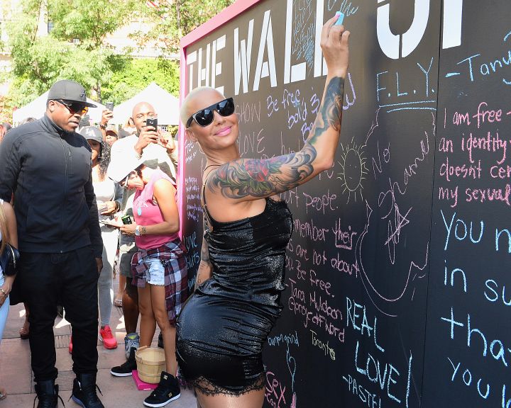 Amber Rose writing on the Wall Of Shame at the SlutWalk.