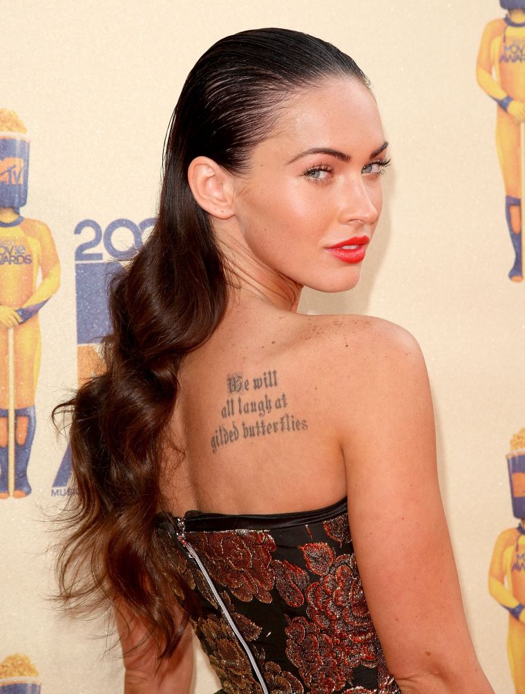 Megan Fox's tattoo, "We will all laugh at gilded butterflies," is an adaptation of a quote from King Lear by William Shakespeare.