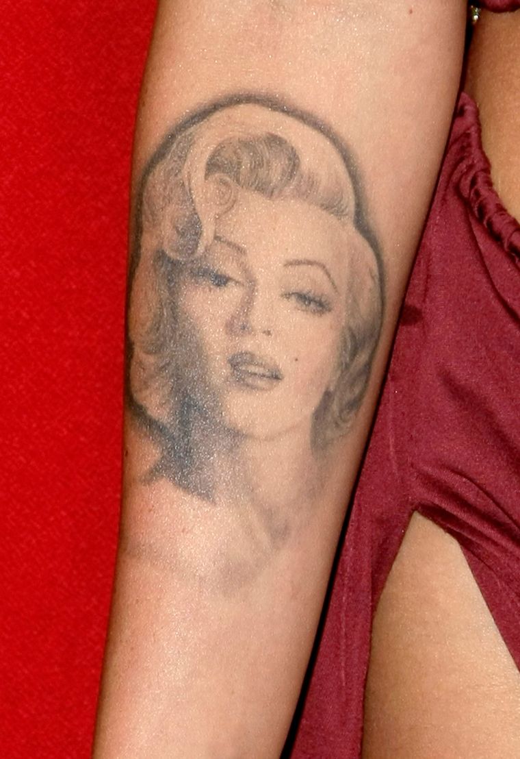 Megan has started laser surgery to remove her infamous Marilyn Monroe tattoo.