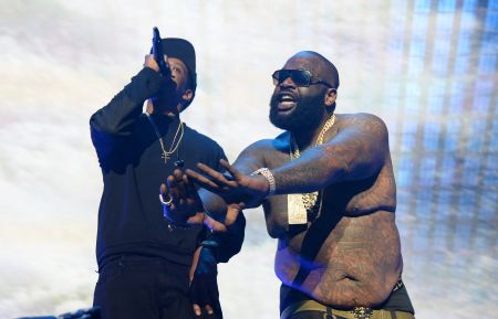 Rick Ross throws up the Roc sign as Hov spits his lyrics and dabs.