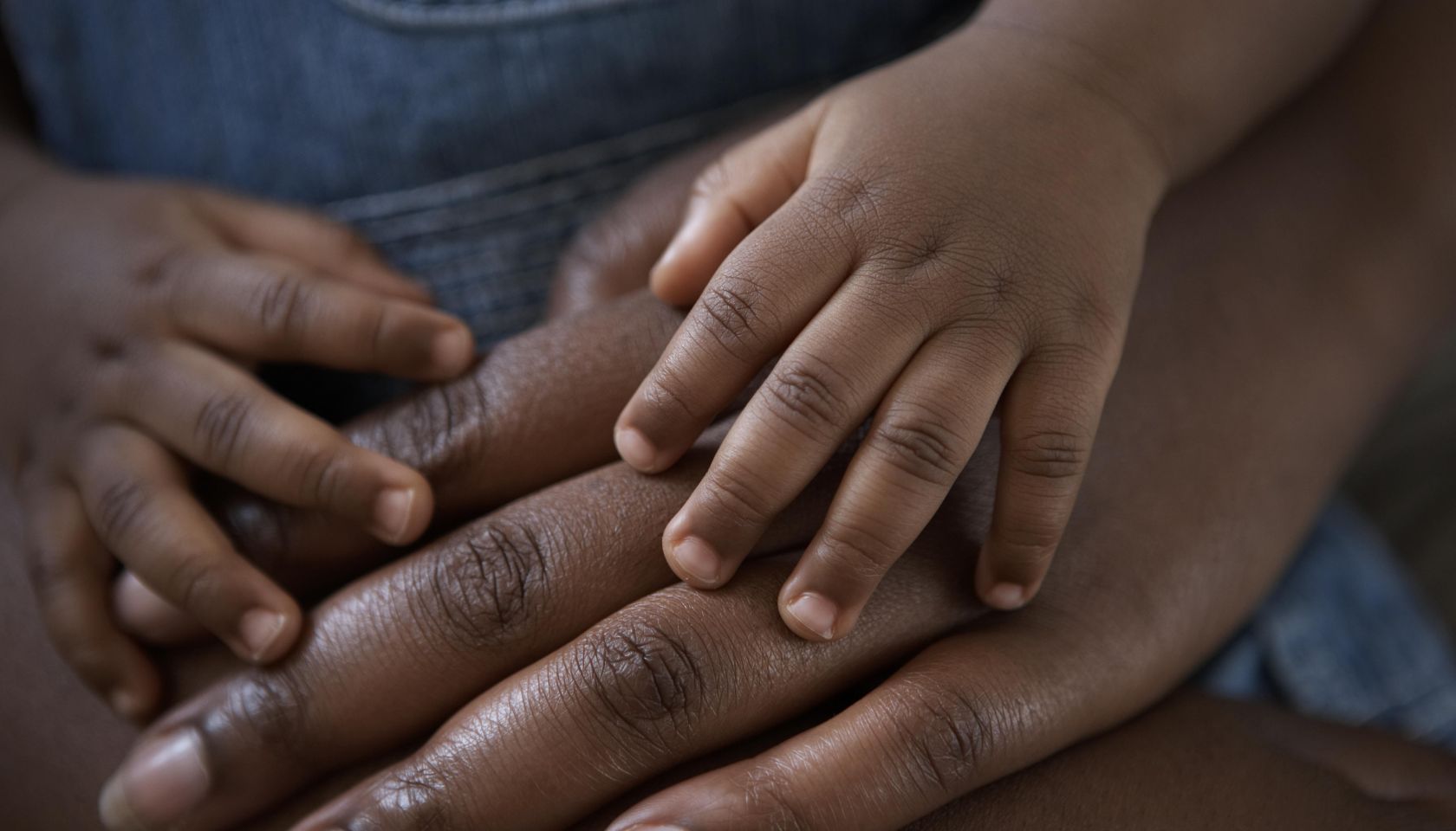 babies hands on top of mums hands