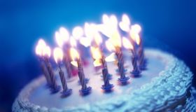 tungsten toned close-up of an array of candles on a birthday cake