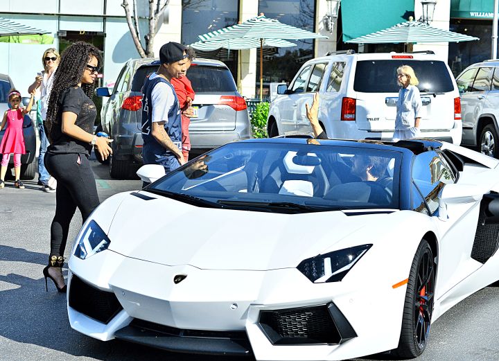 Tyga, Chyna, and King Cairo casually spending time with Scott Disick and his Lamborghini.