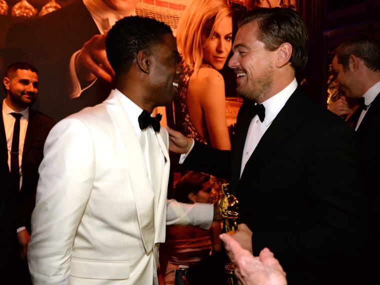 Chris Rock talks with the night’s big winner, Leonardo DiCaprio.