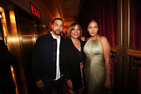 La La stands by her mom and brother.