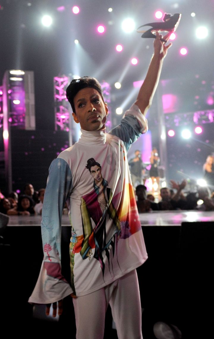 Musician Prince holds up singer Patti LaBelle’s shoe during her performance at the 2010 BET Awards held at the Shrine Auditorium on June 27, 2010.