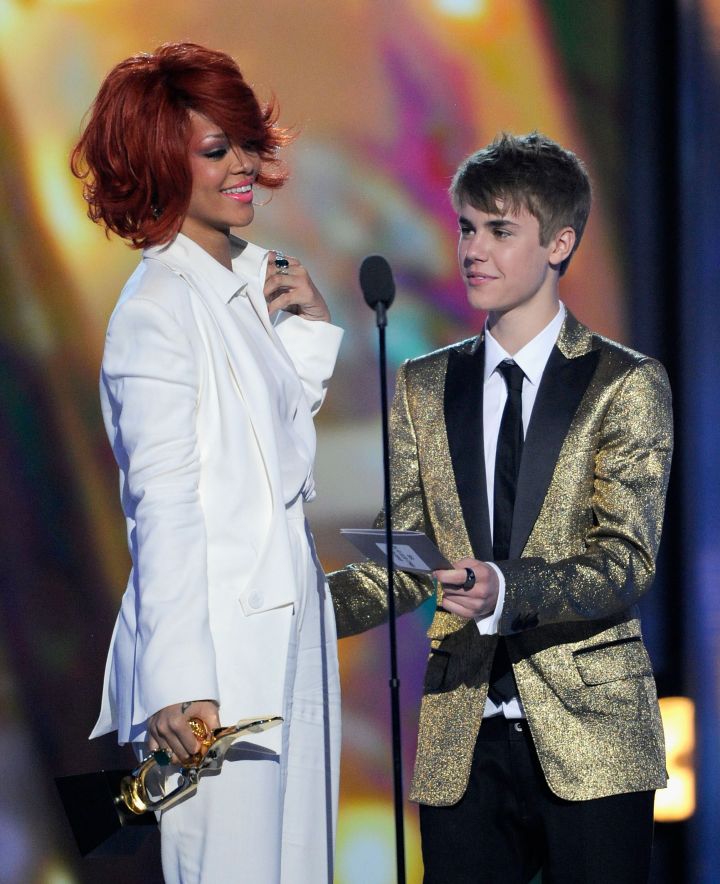 Pre-bad boy behavior Justin Bieber presenting an award to a then red-haired Rihanna in 2011.