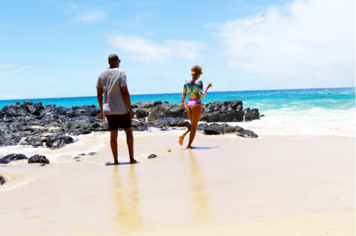 Bey takes a walk on the sand with her hubby.