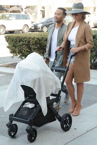 Chrissy Teigan and John Legend shopping and pushing stroller through Beverly Hills, CA