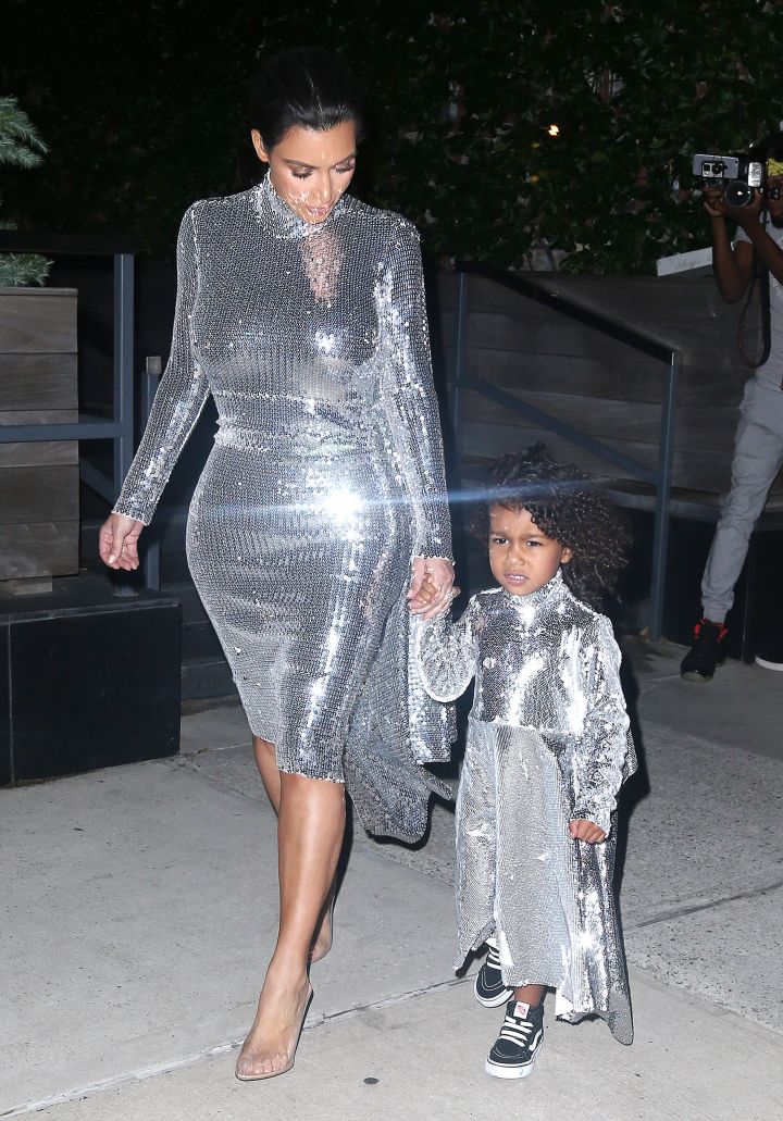 Kim Kardashian takes out North West in matching silver sequined outfits.