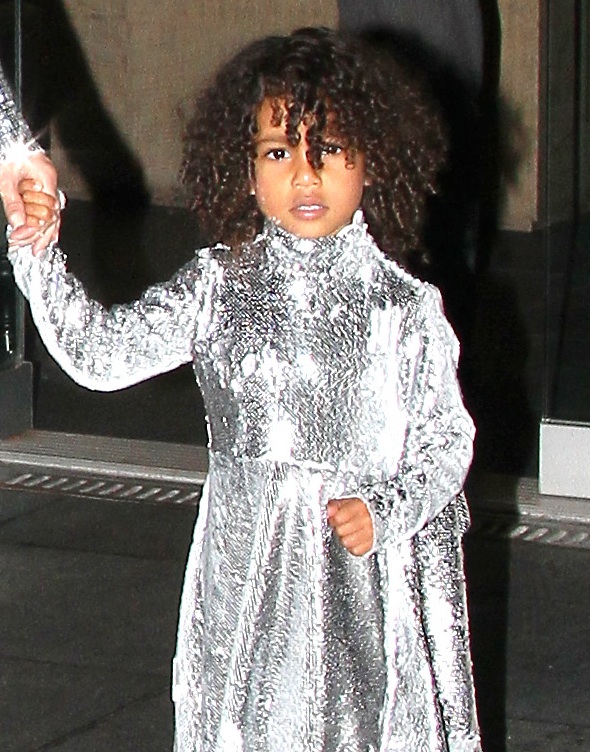 North West learning the family business in her silver sequins.