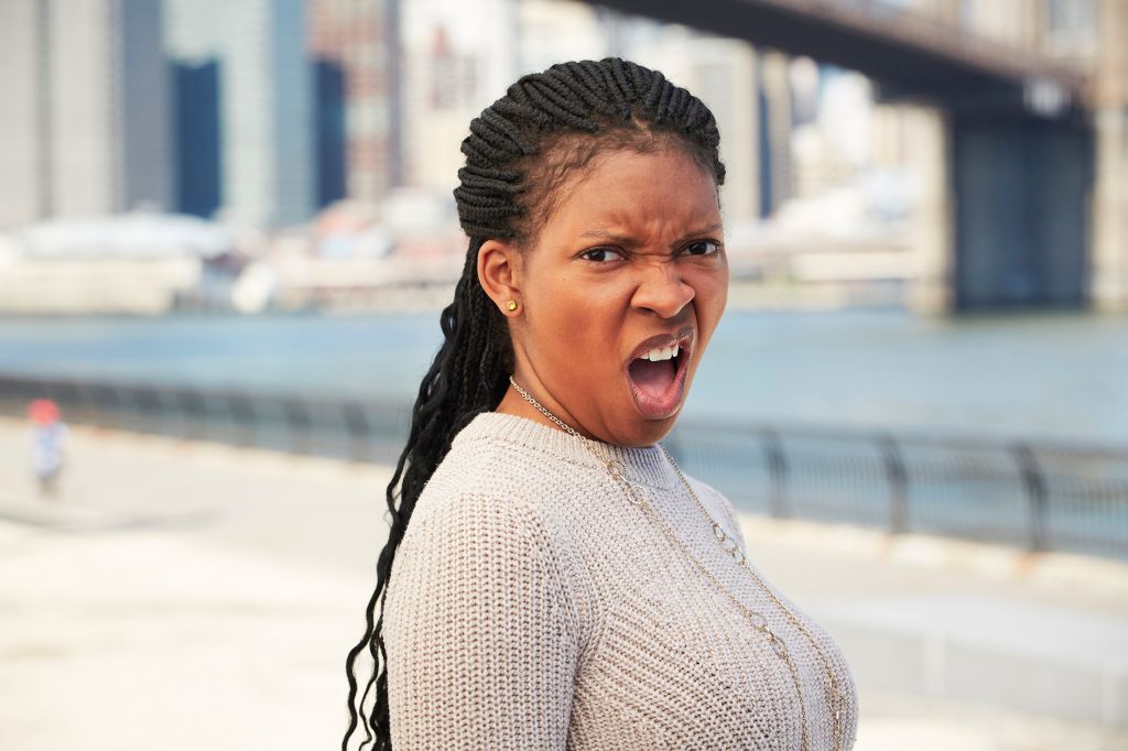 Black woman with disgusted attitude at waterfront