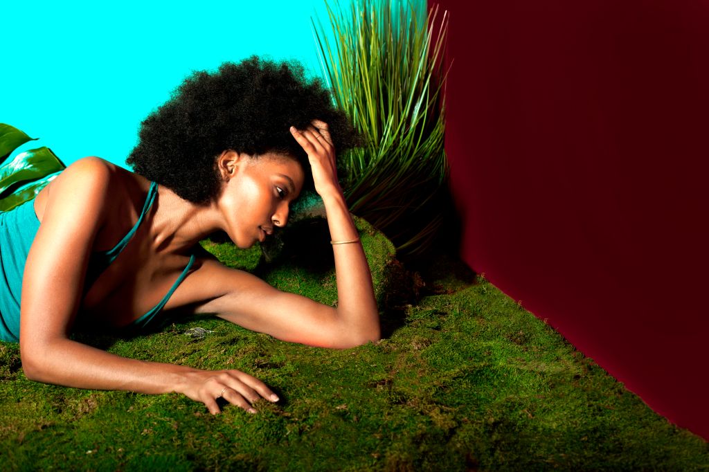 Woman with Afro in colorful nature room