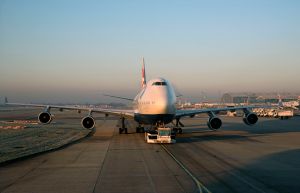 Passenger Jet Being Moved Using An Aircraft Tractor at Heathrow Airport