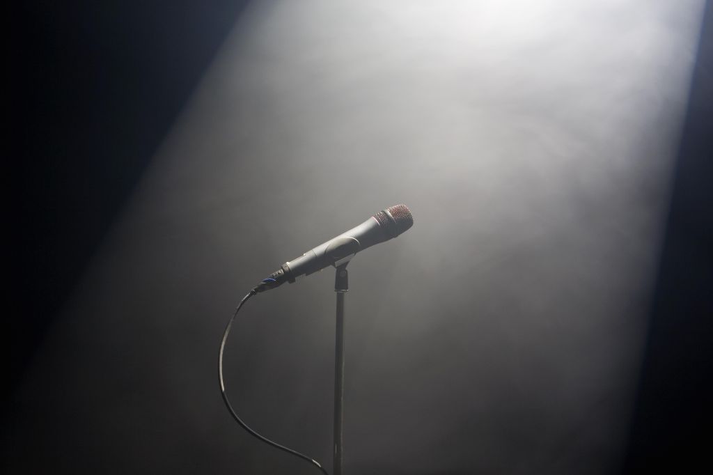 A spot lit microphone stand