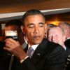 US President Barack Obama reacts after t