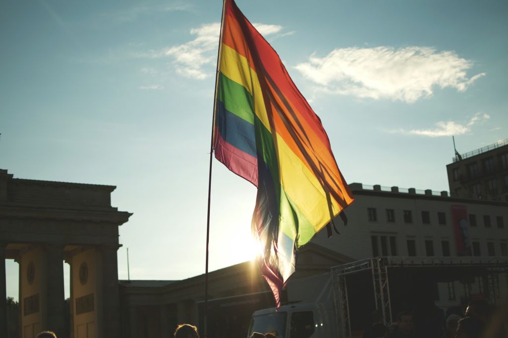 Low Angle View Of Rainbow Flag At Brandenburg Gate Against Sky