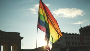 Low Angle View Of Rainbow Flag At Brandenburg Gate Against Sky
