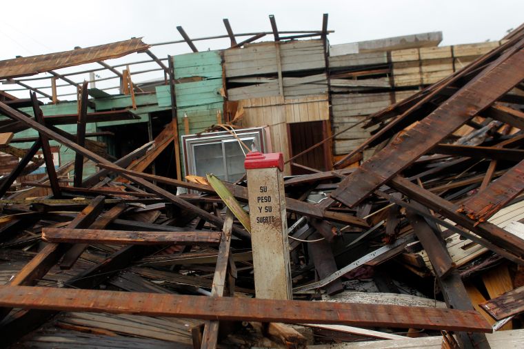 Fajardo, PR: A coin weighing scale lies between debris from a destroyed bar.