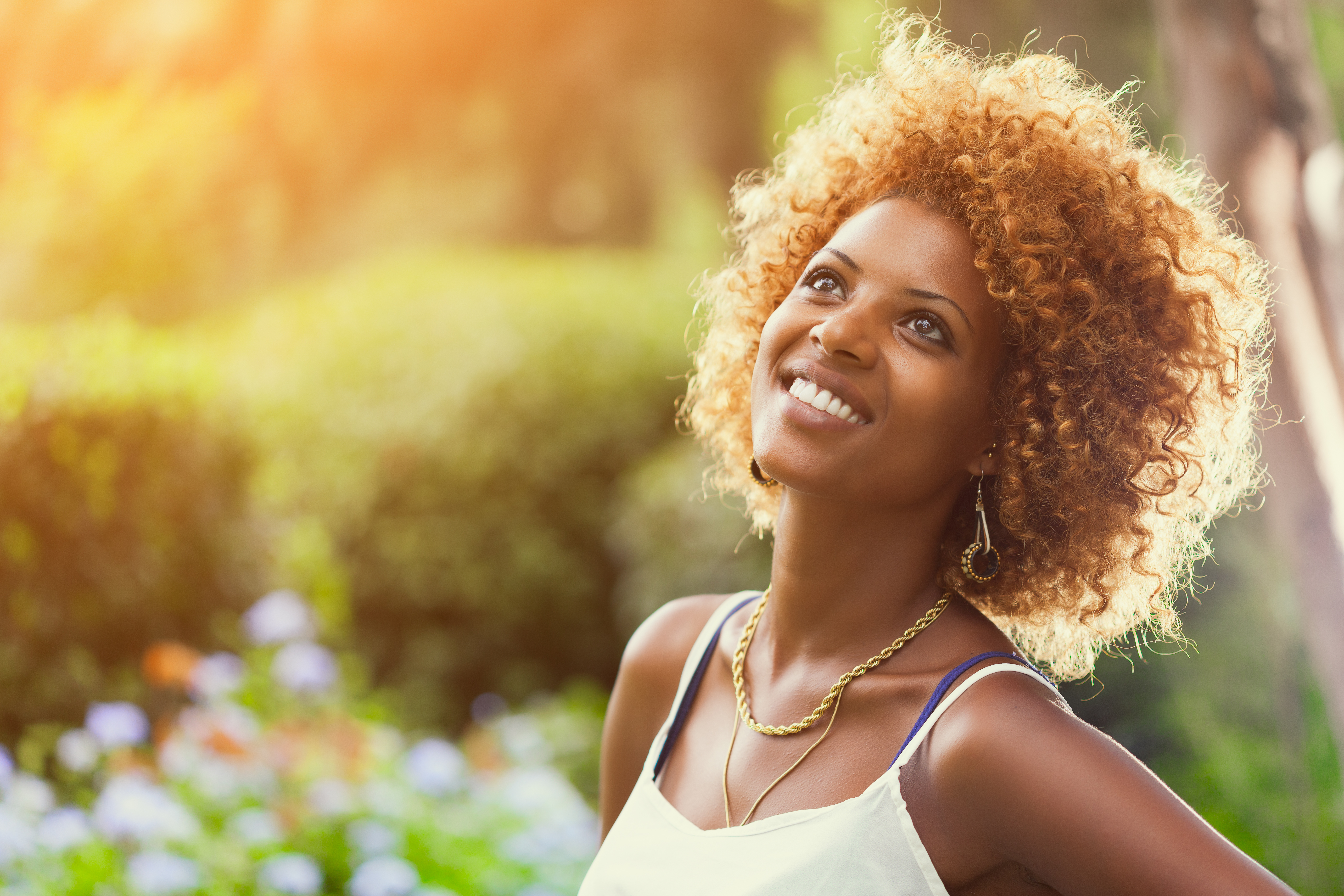 Smiling African woman in sunshine Outdoors profile portrait