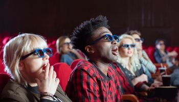Young people in 3D movie theater