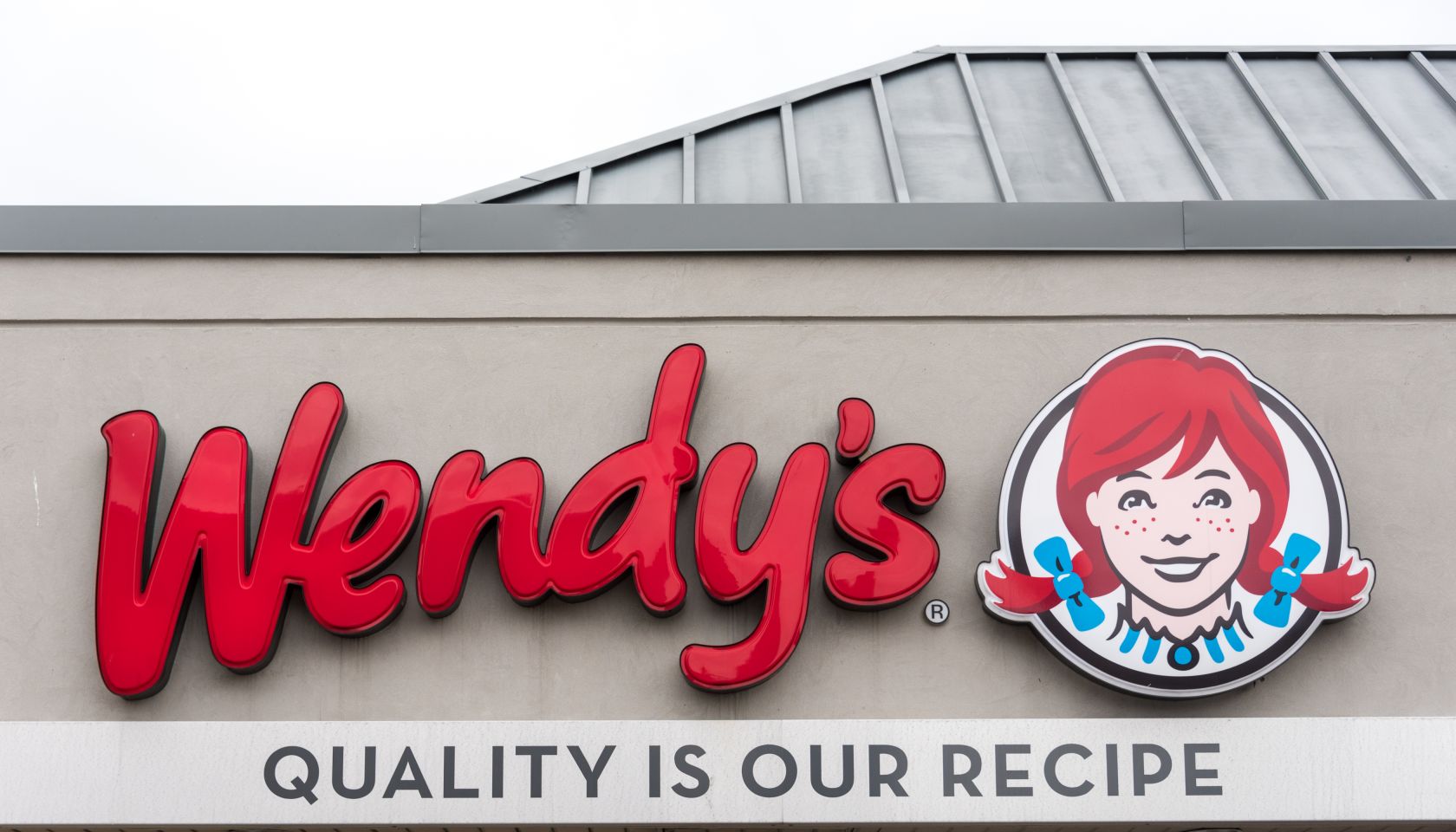 Wendy's sign. Entrance of an outlet of famous American fast...