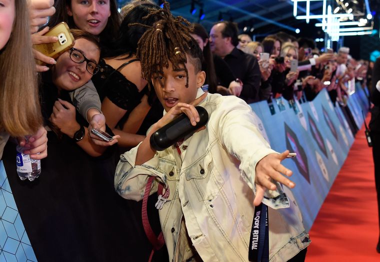 Jaden Smith holding a speaker.