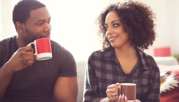 Afro american couple drinking coffee at home