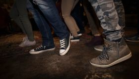 Legs of young friends dancing at party