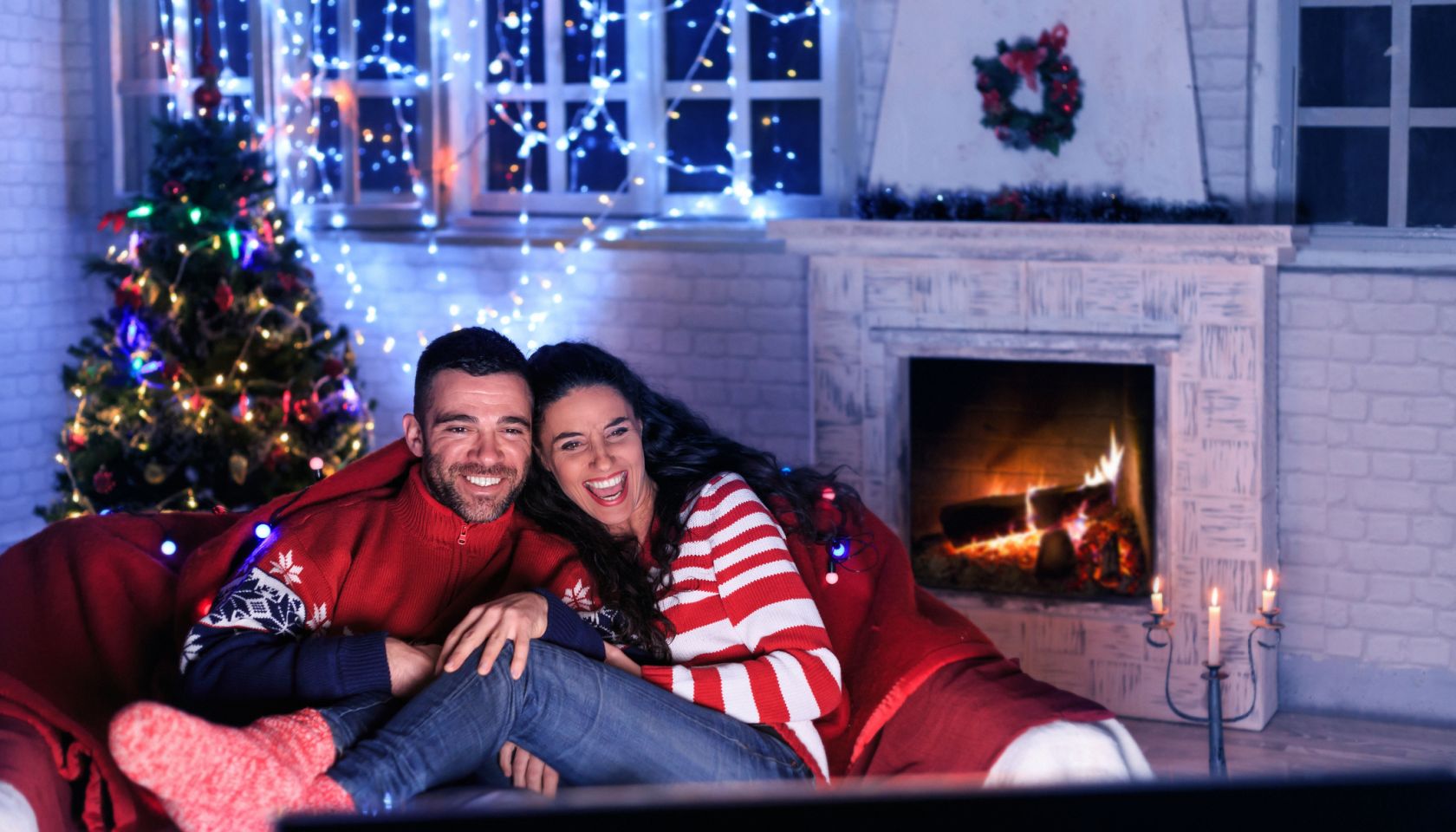 Couple watching TV at home