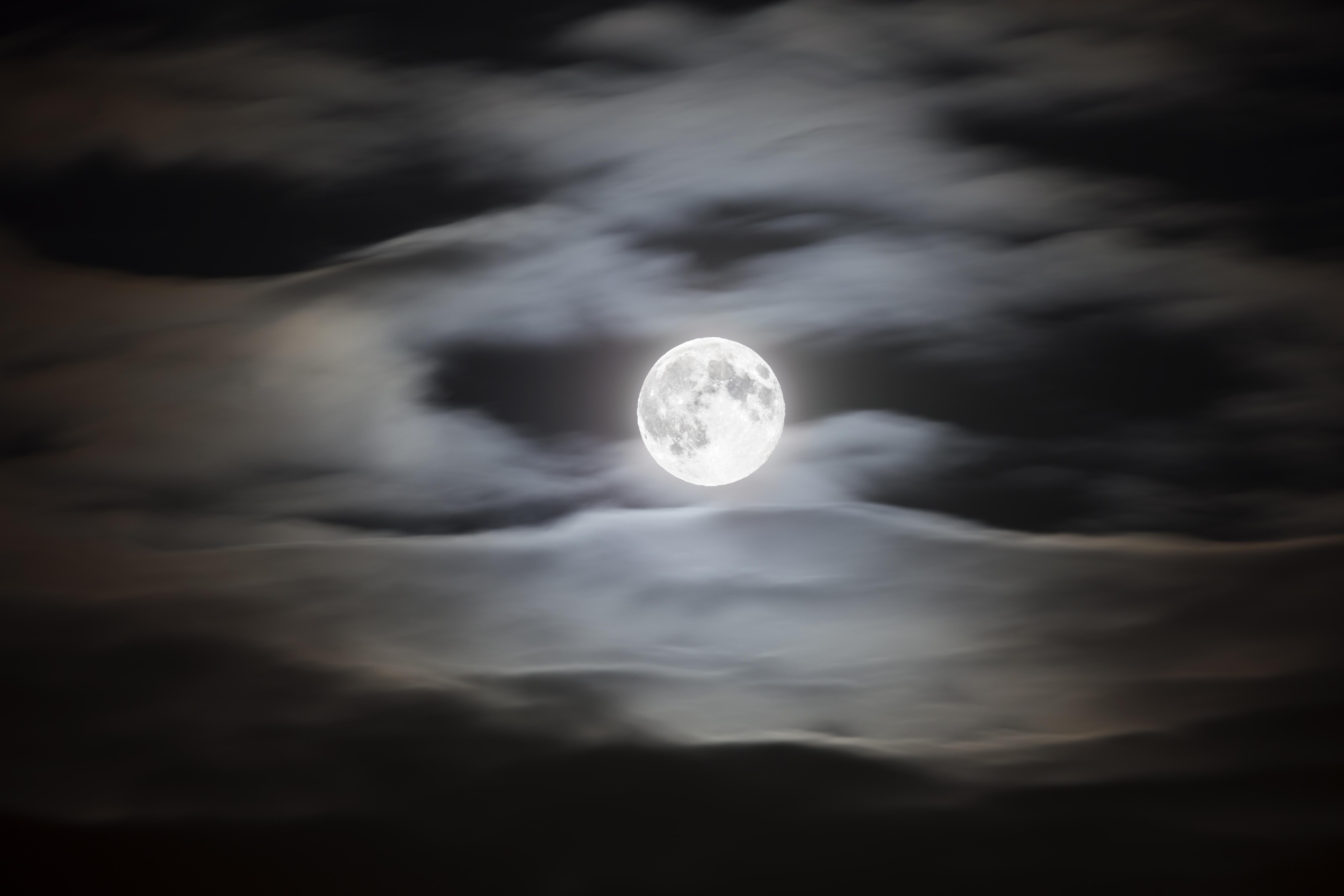 Full moon on a cloudy night sky