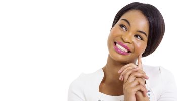 thoughtful african american woman smiling on white background
