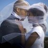 Profile of a newlywed young couple under a veil