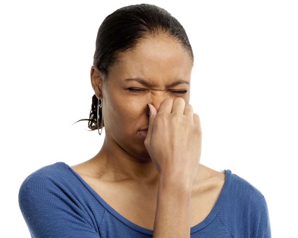 Frowning Young Woman Pinching Nose