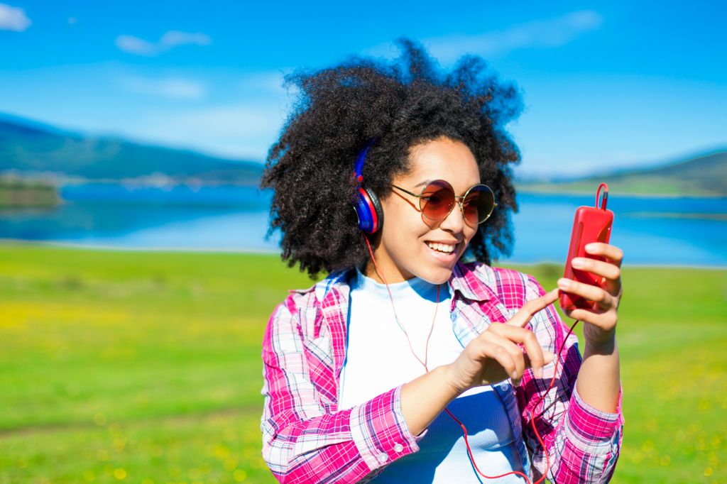 Woman listening to music in the nature.