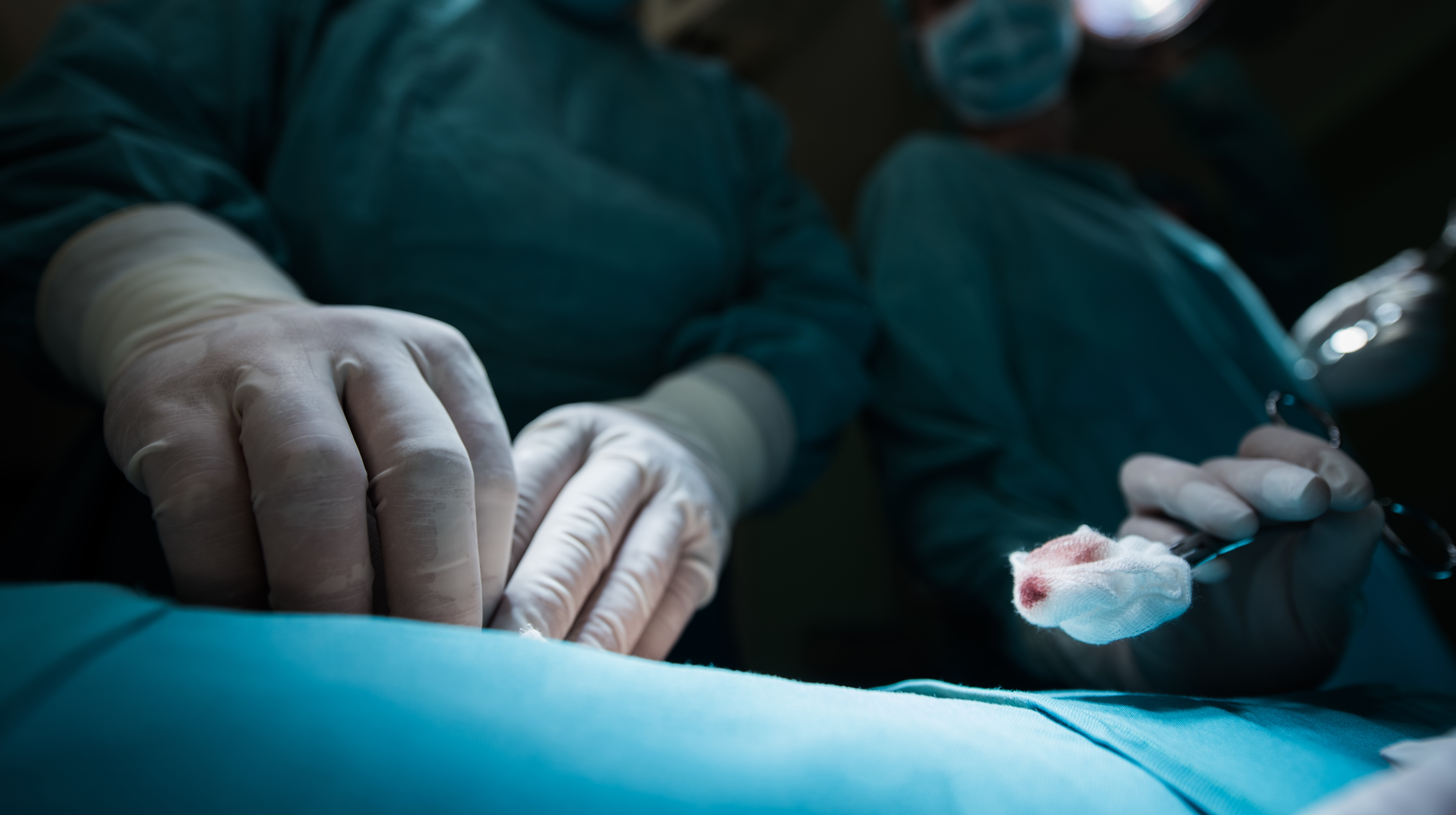 Close up of surgeons using cotton swab on a surgery.