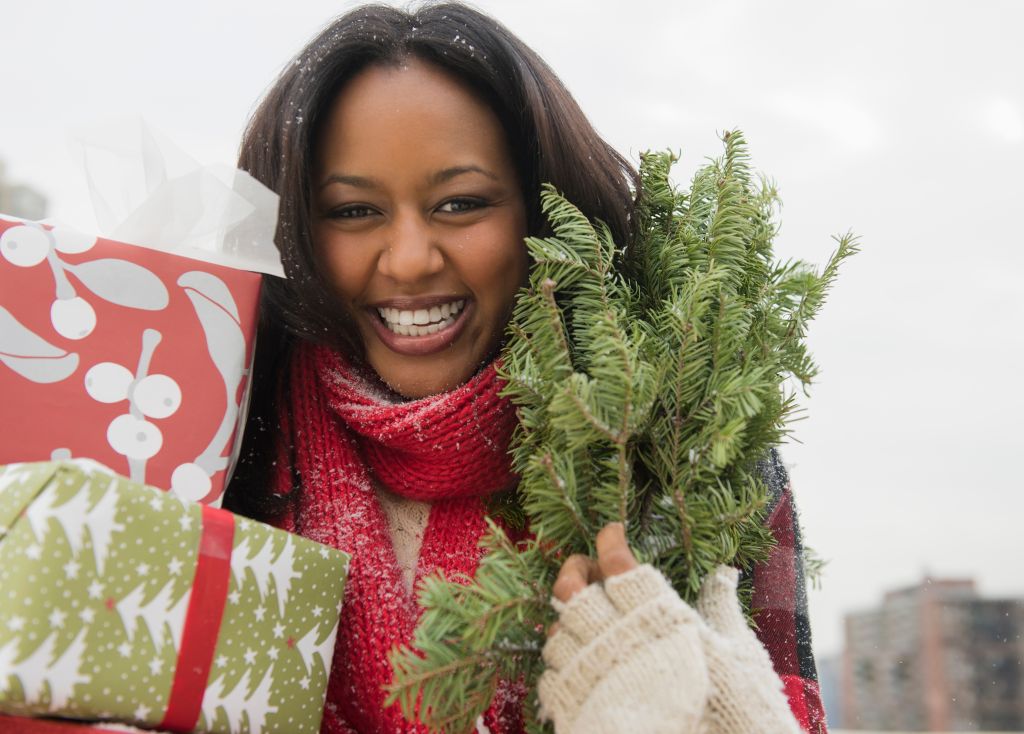 African American woman carrying Christmas presents