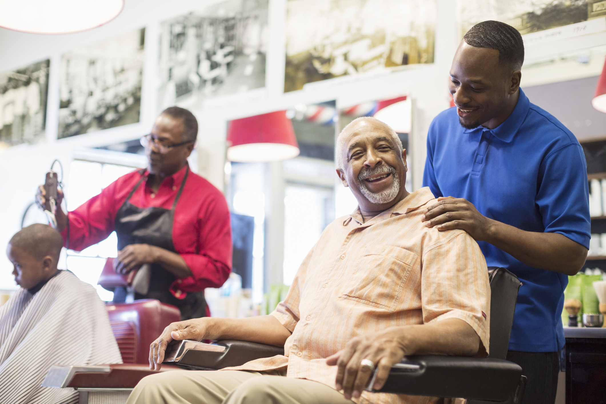 Black barber talking to customer in retro barbershop