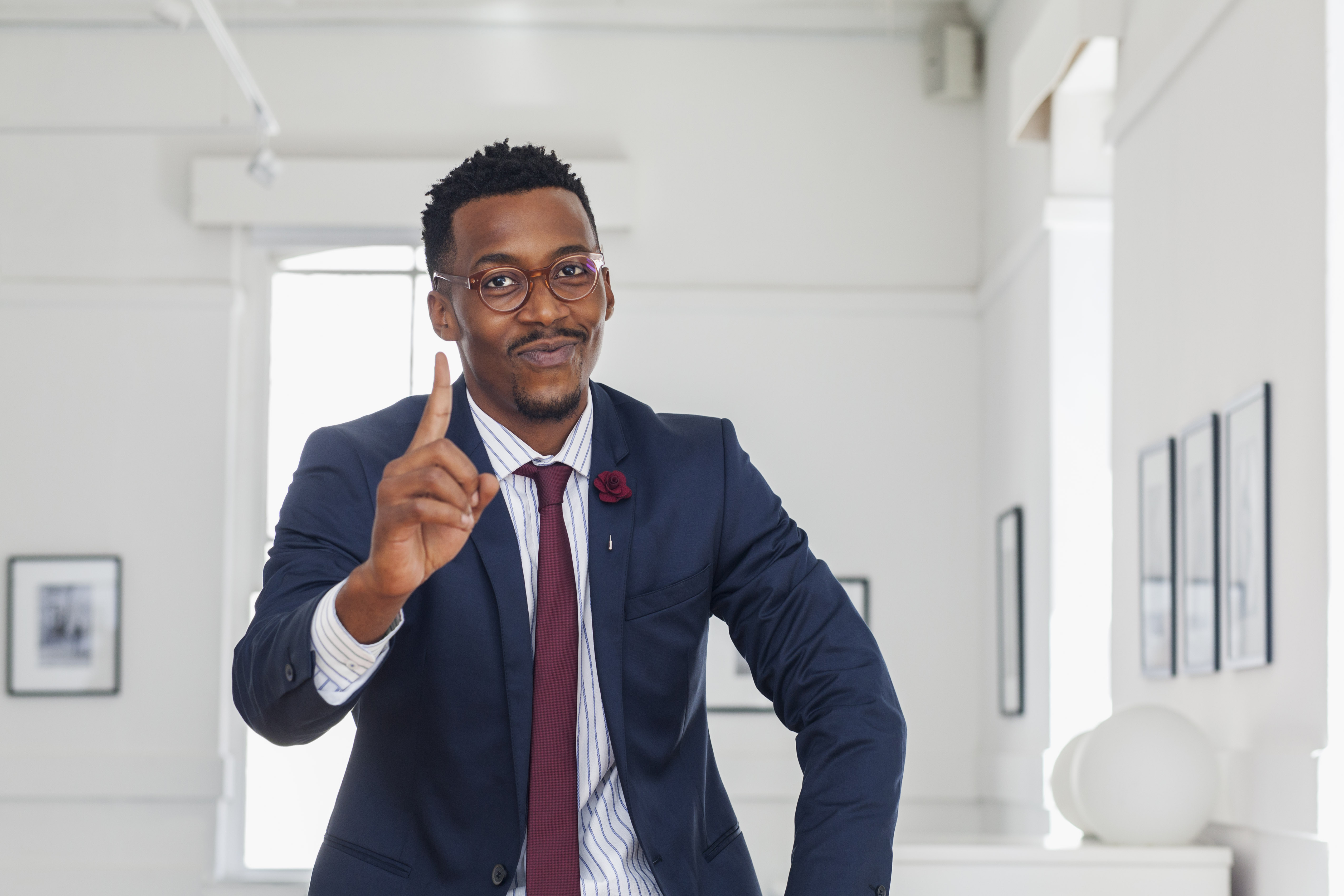 Black man gesturing in gallery