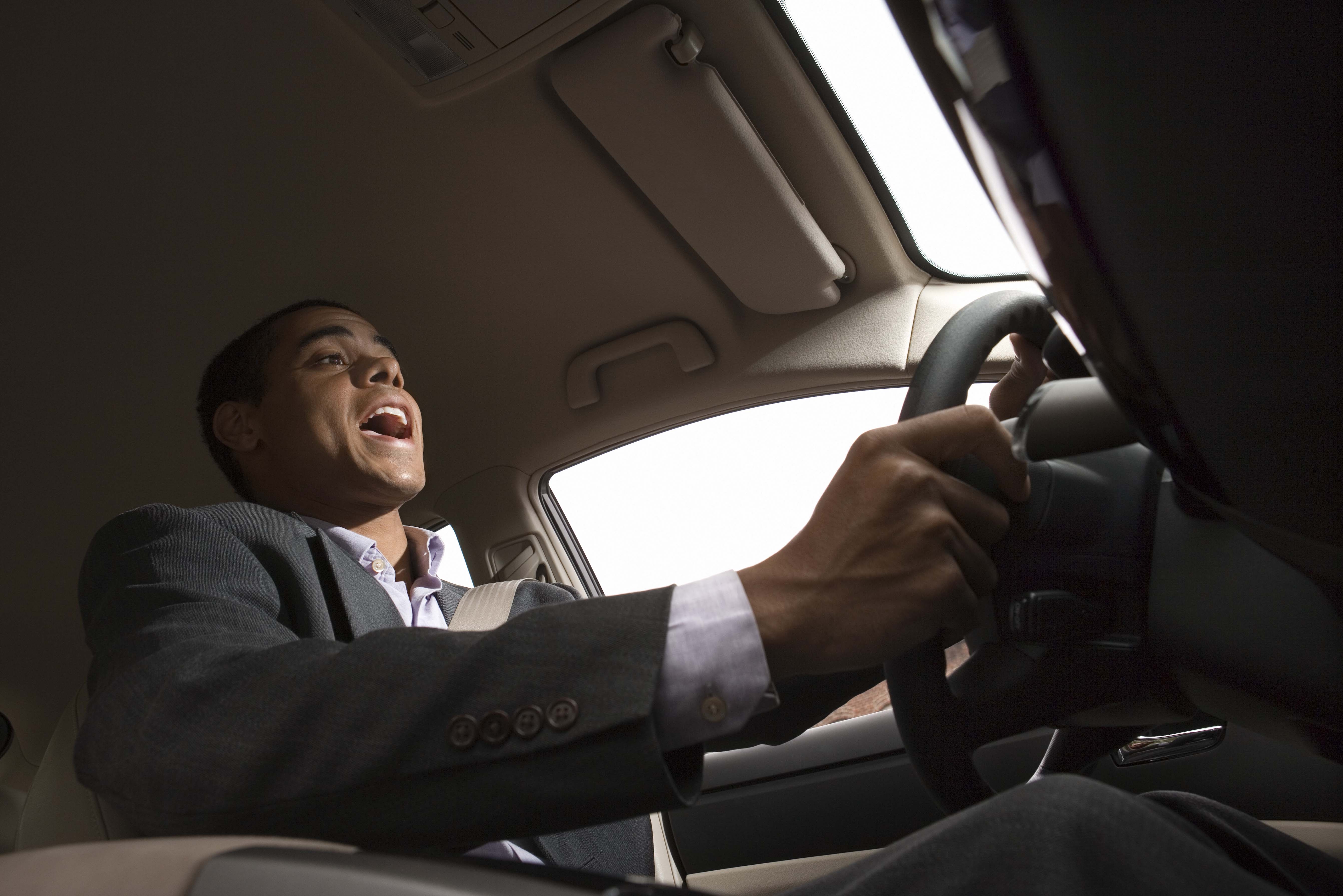 Businessman singing while driving