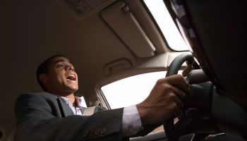 Businessman singing while driving