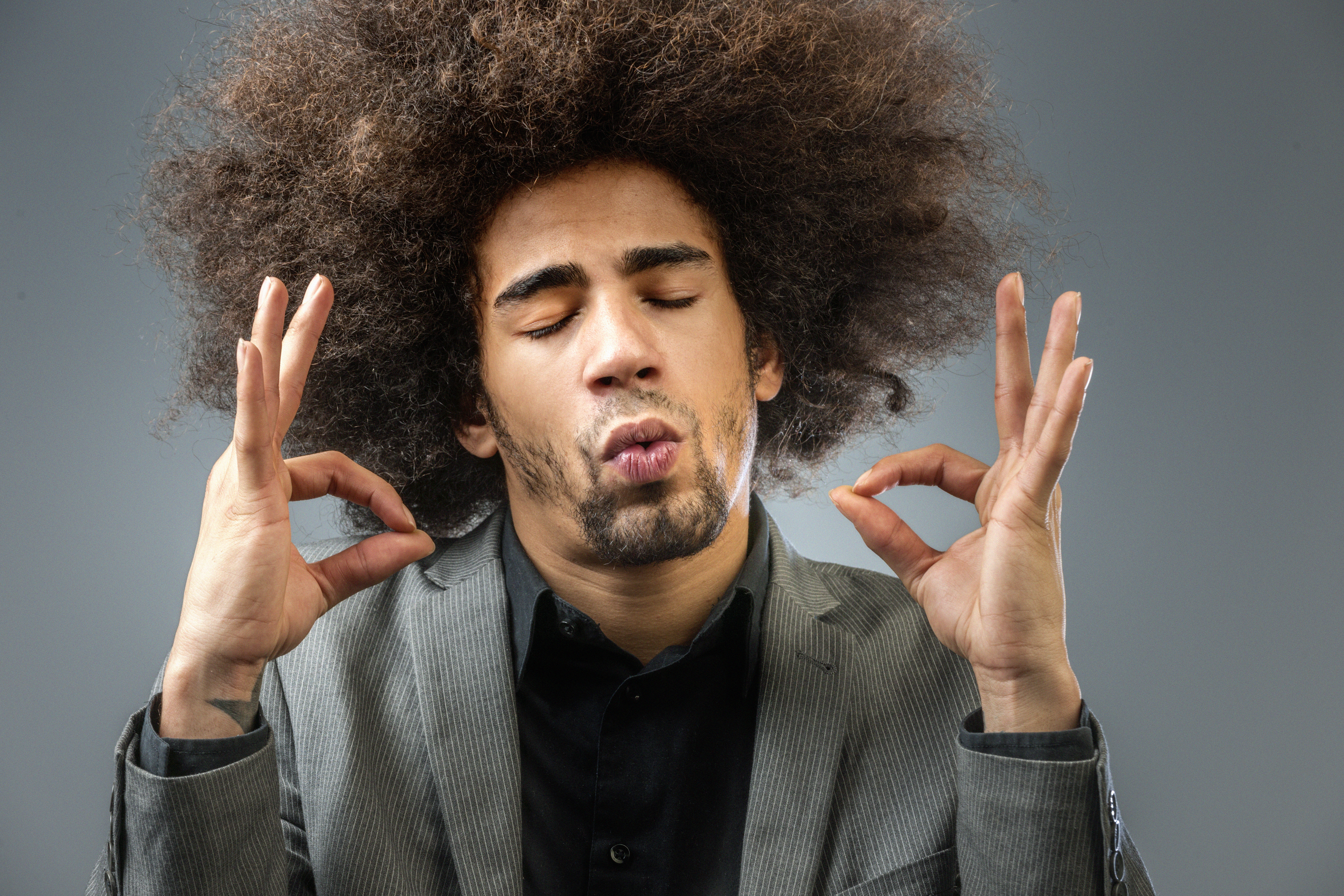 yoga meditating man with big afro hair