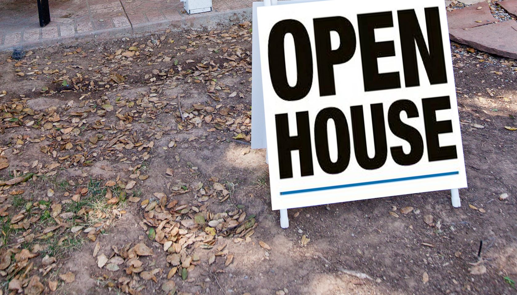 Woman standing in front of a house for sale