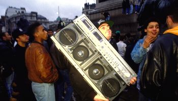 Protestor at 'Freedom to Party' demonstration carrying a just about portable tape deck Trafalgar Square London 1990